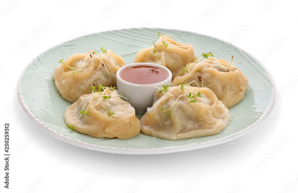 Plate with tasty dumplings and sauce on white background