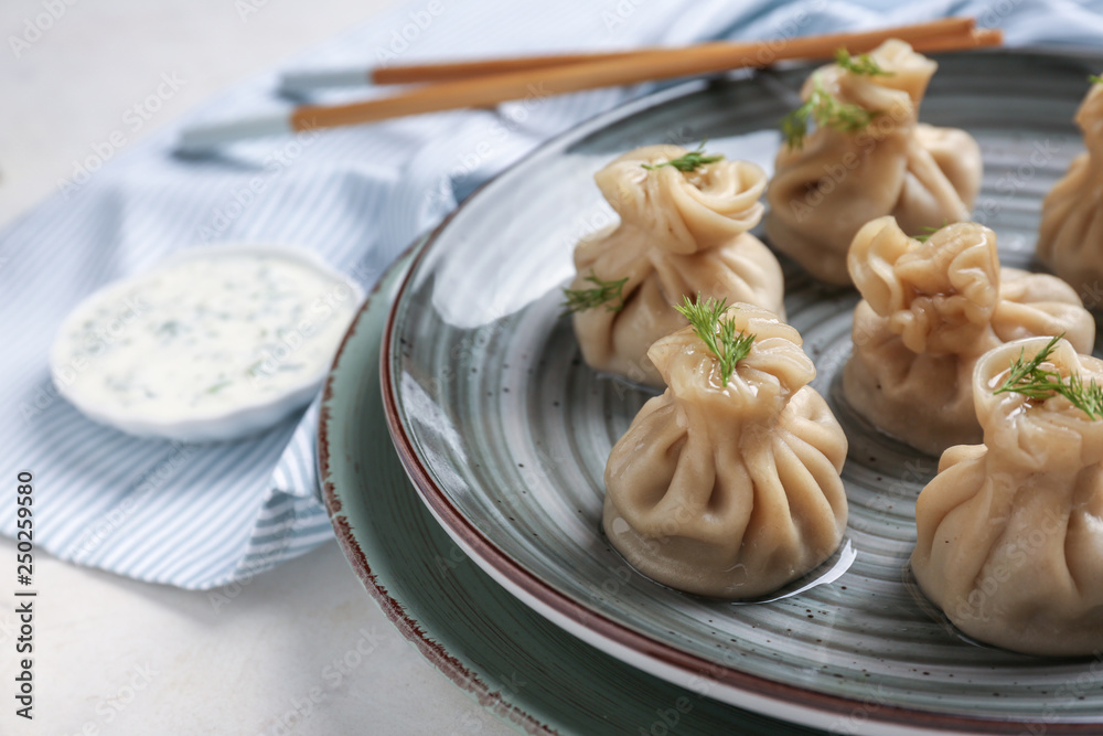 Plate with tasty dumplings on table, closeup Plate with tasty dumplings on table, closeup