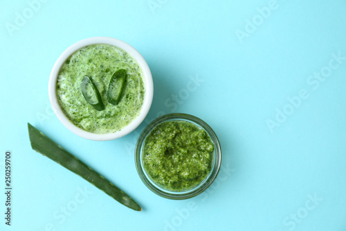 Facial mask with aloe vera extract on color background