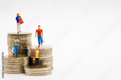 Miniature of shopping women and men on coins stacking with white background. Shopping and copy space concept - Image