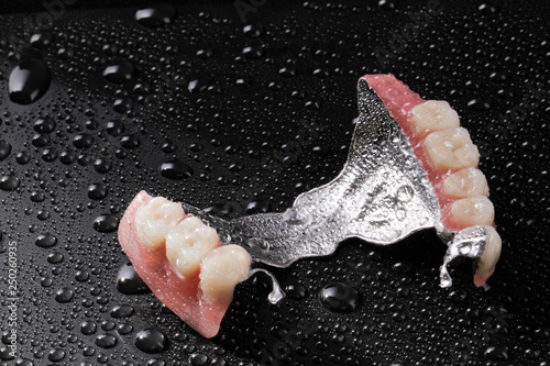 Combined fixed and mobile prosthesis on dark background