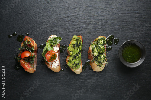 Fototapeta Naklejka Na Ścianę i Meble -  Fresh tasty bruschettas on dark background