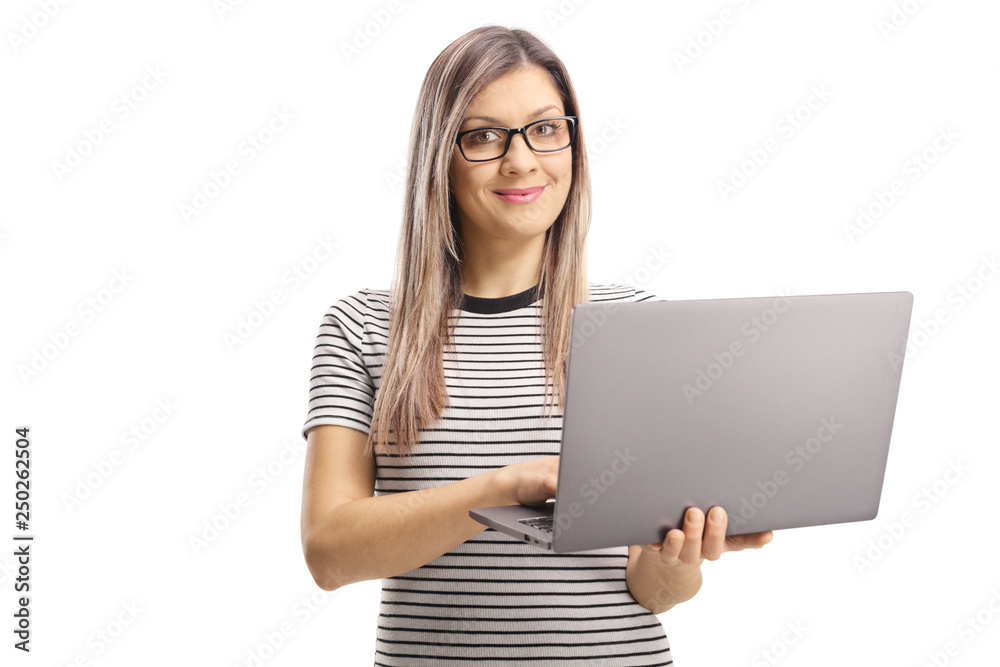 Young woman using a laptop computer and smiling at the camera Young woman using a laptop computer and smiling at the camera