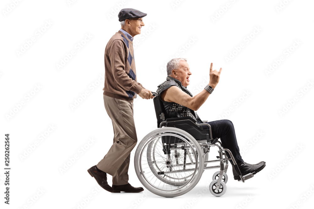 Elderly man pushing a man making a rock and roll hand sign in a wheelchair Elderly man pushing a man making a rock and roll hand sign in a wheelchair