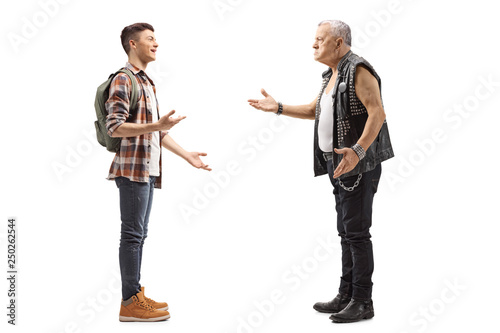 Male teenage student talking to a mature male punker in a leather vest