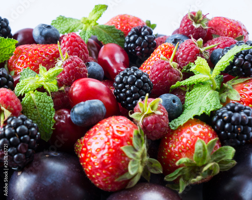 Ripe strawberries  blackberries  blueberries  raspberries  red berries and plum. Top view. Red and pink food. Background berries and fruits. Black-blue and red food.