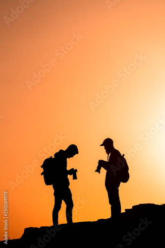 Photographers who shoots a sunset in the mountains