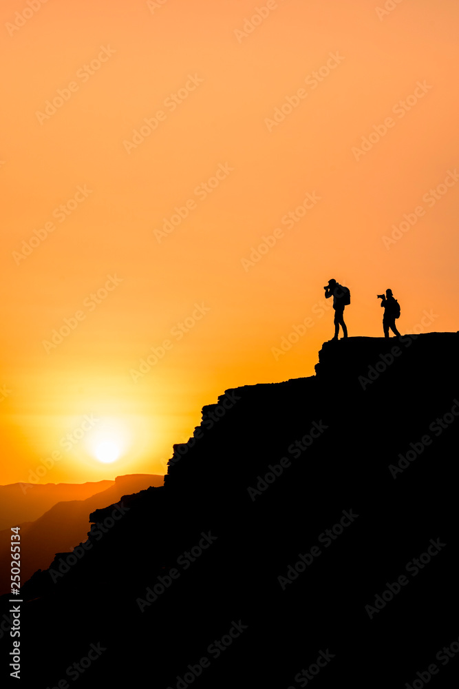 Photographers who shoots a sunset in the mountains Photographers who shoots a sunset in the mountains