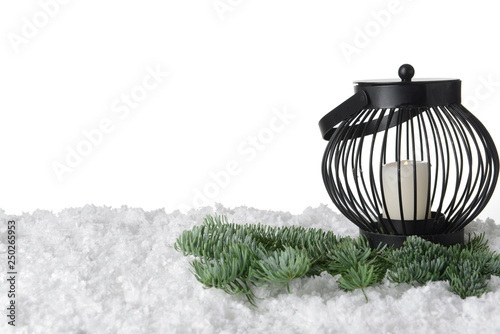 Lantern with snow and fir tree branches on white background