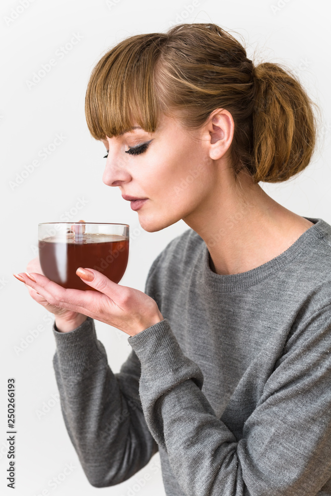 The young girl smells a smell of hot tea The young girl smells a smell of hot tea