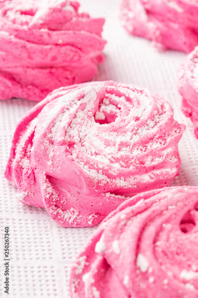 Homemade pink marshmallow on a white kitchen napkin close-up. Homemade pink marshmallow on a white kitchen napkin close-up.