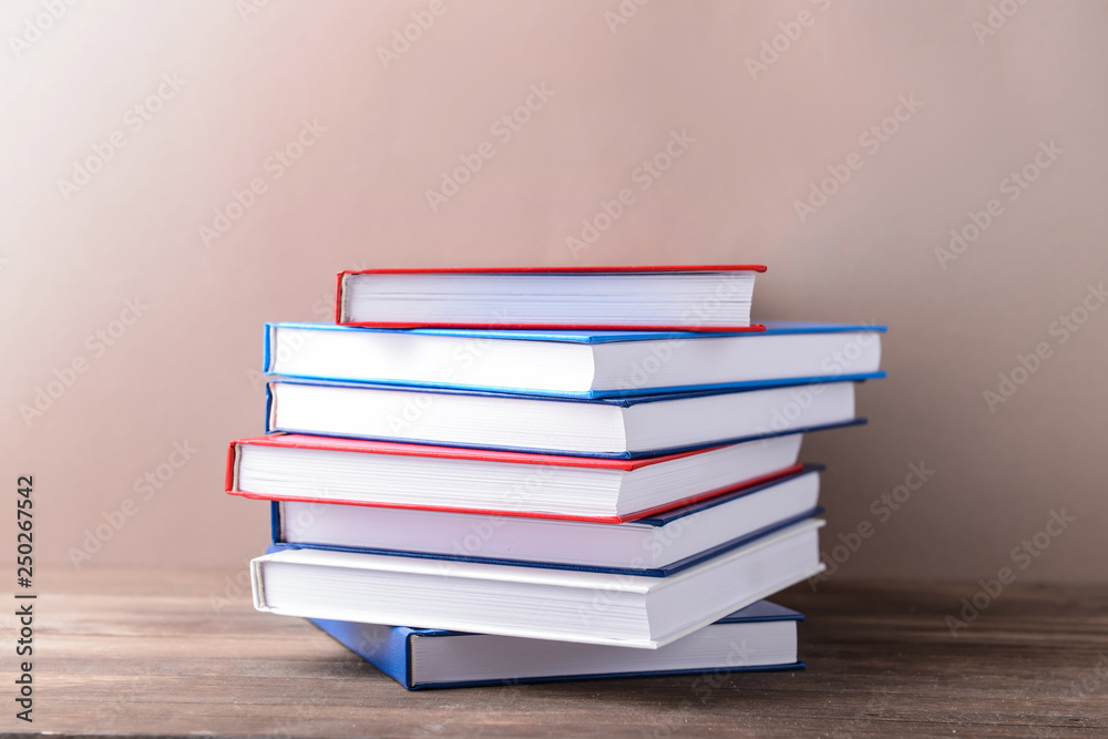 Many books on table against color background Many books on table against color background