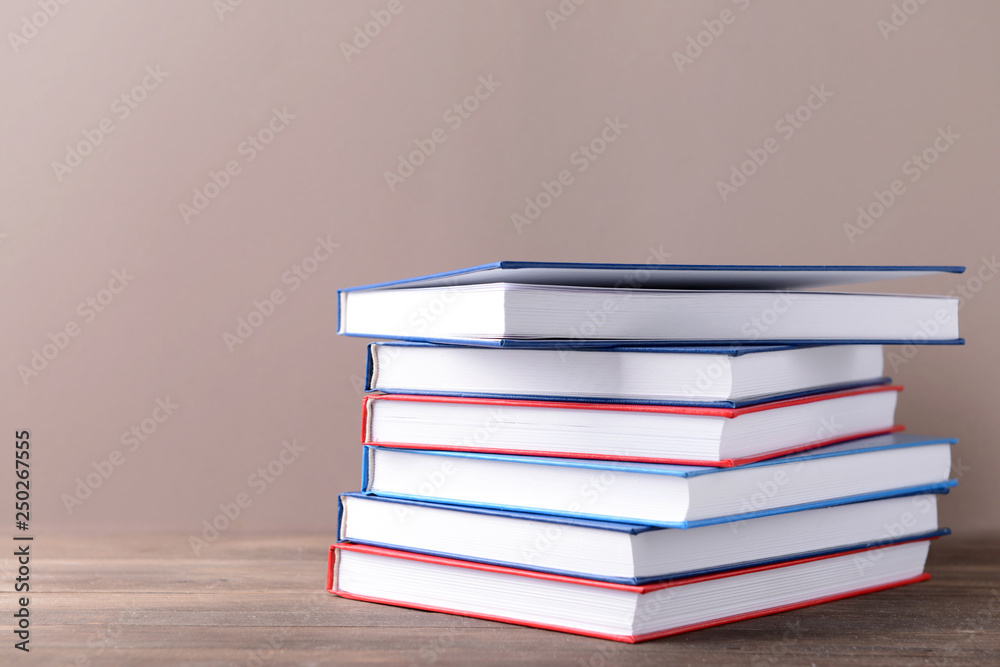 Many books on table against color background Many books on table against color background