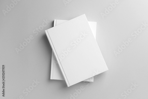 Books with blank covers on light background © Pixel-Shot
