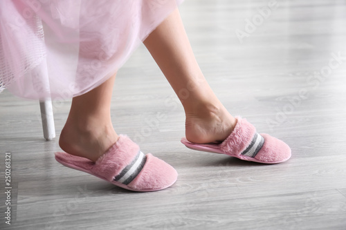 Young woman in slippers at home