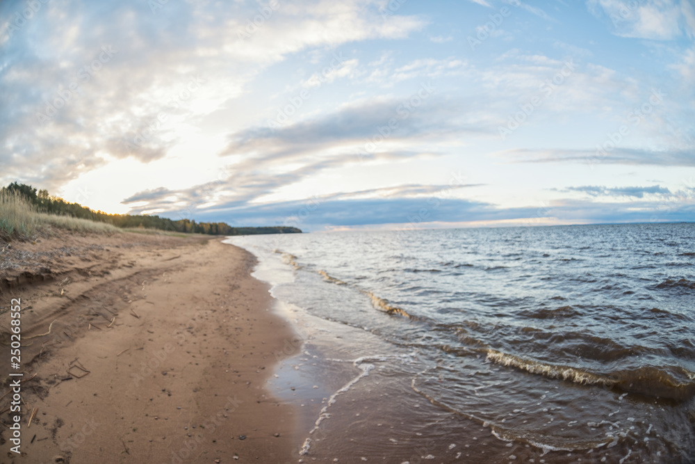 unfocused beach with sunset sky and sun