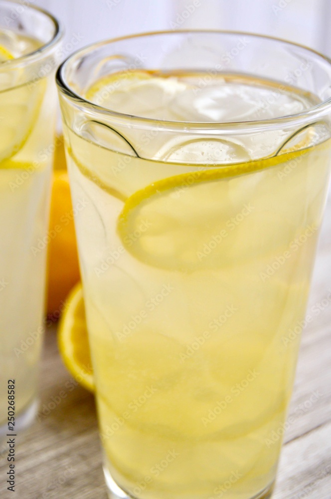Two glasses of lemonade on a wooden surface Two glasses of lemonade on a wooden surface