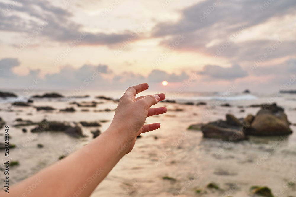 Girl reaches out to the clouds. Girl pulls her hand to the sea. Girl reaches out to the clouds. Girl pulls her hand to the sea.
