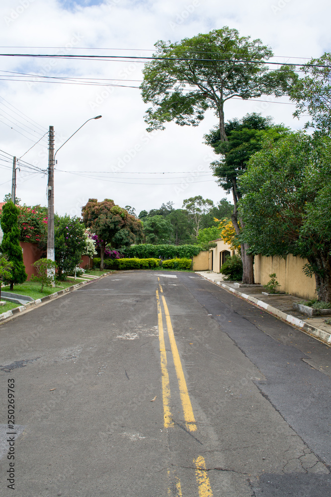 Typical street view of the nice city of Atibaia, Sao Paulo, Brazil. Every street is full of colorful greenery and natural features which provide good shadows and sun repair Typical street view of the nice city of Atibaia, Sao Paulo, Brazil. Every street is full of colorful greenery and natural features which provide good shadows and sun repair