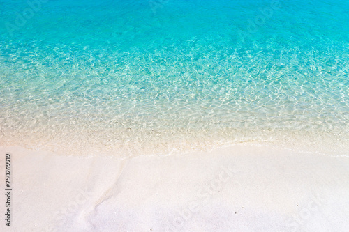 Wave of the sea on the sand beach.Tropical beach with Blue sky and clear sea.