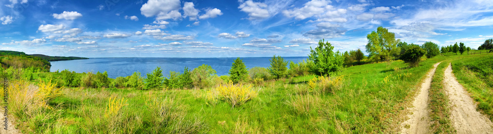 Beautiful panorama of Kaniv Reservoir shore, Ukraine, in sunny day with bright cloudy sky