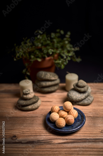 composition of candles, stones and wooden spa balls