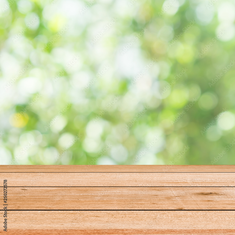 abstract blurred green nature with plank table for show,promote,ad product on image concept abstract blurred green nature with plank table for show,promote,ad product on image concept
