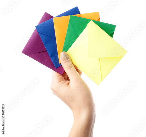 Female hand with envelopes on white background
