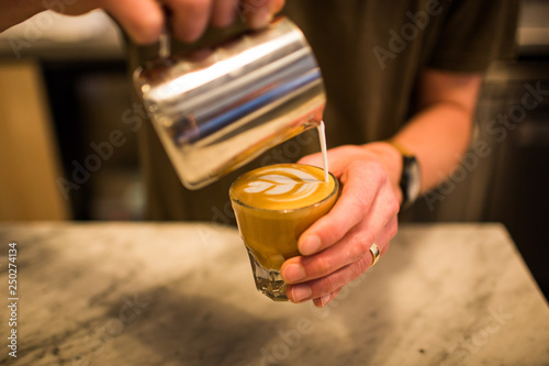 Barista pouring cortado closeup latte art gorgeous photo