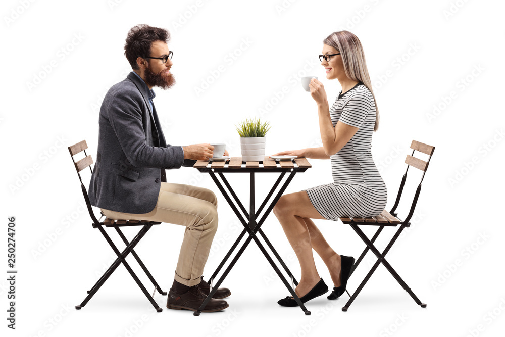 Obraz premium Young man and woman drinking coffee at a table