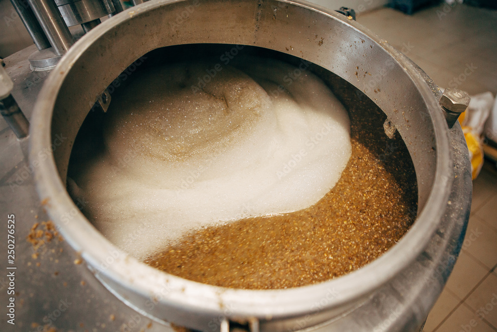 Beer brewed in a brewery. Brewing equipment at microbrewery Beer brewed in a brewery. Brewing equipment at microbrewery
