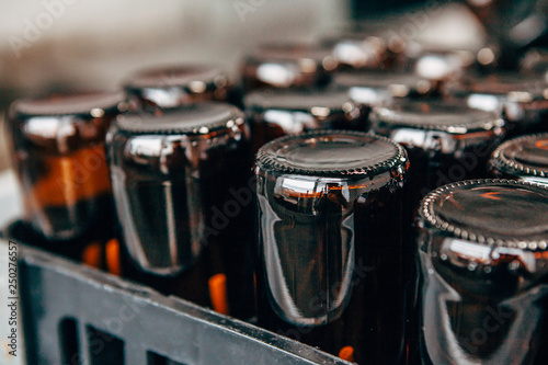 close-up of empty beer bottles upside down in a plastic box