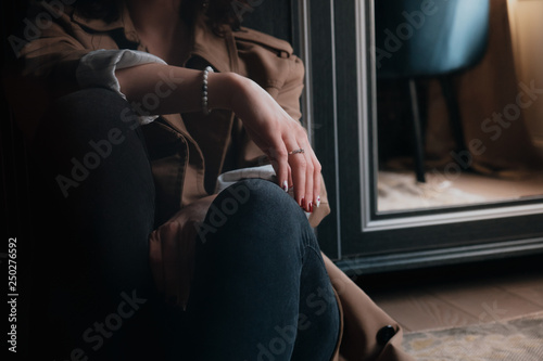 Close-up life-style shot stylish woman sitting on floor with her hand in focus photo