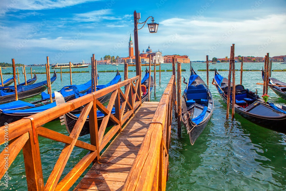 wooden harbor with gondolas in Venice