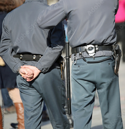 two policemen on patrol with handcuffs and buggy during the patr photo