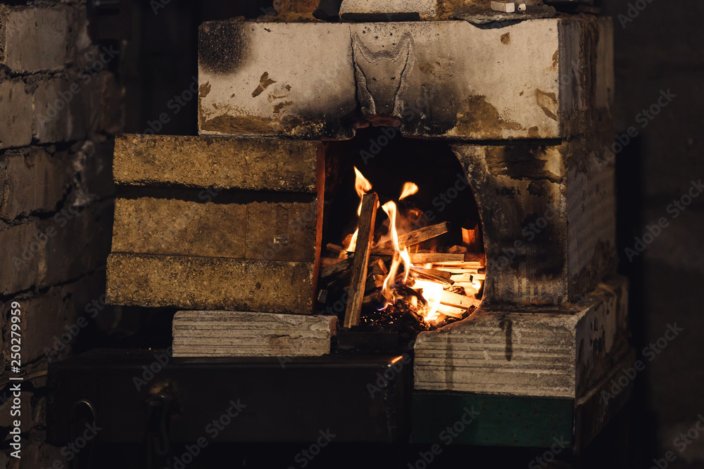 close up photo of homemade forge furnace with flame.