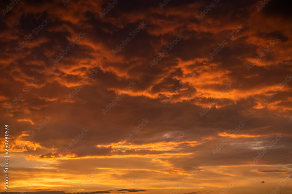 Abstract nature background. Dramatic and moody yellow cloudy sunset sky