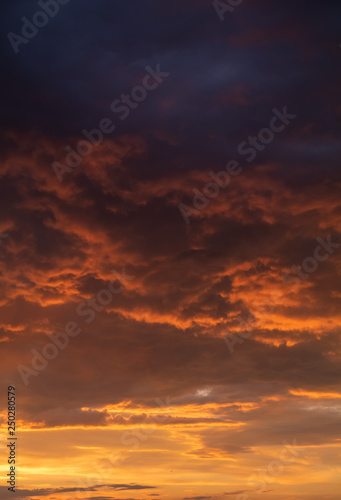 Abstract nature background. Dramatic and moody yellow cloudy sunset sky