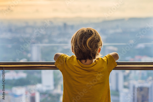 Photography Little boy looks at Kuala lumpur cityscape
