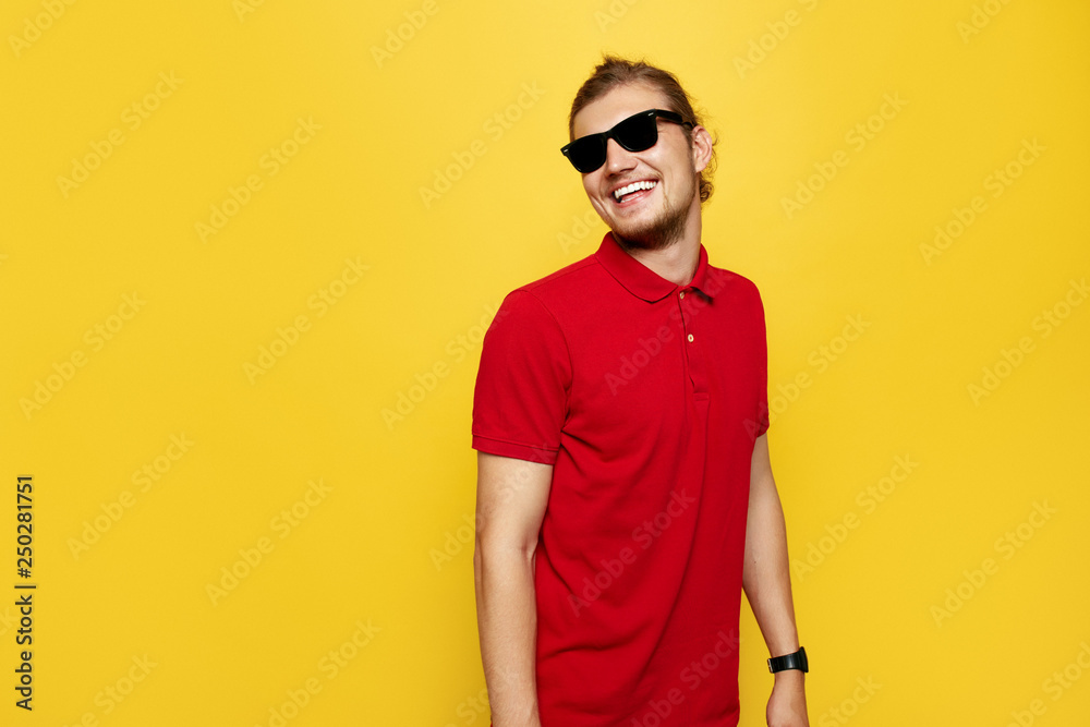 Cheerful handsome man smiles happily, has excited expression, dresssed in red polo shirt, isolated over yellow studio background. People, youth, emotions concept Cheerful handsome man smiles happily, has excited expression, dresssed in red polo shirt, isolated over yellow studio background. People, youth, emotions concept