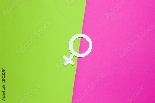 Woman gender symbol on green pink background. Top view. Minimalism. Gender equality