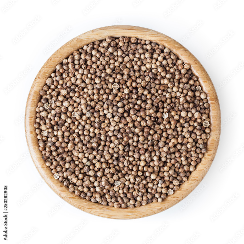 Dried coriander seeds in wooden bowl isolated on white background with clipping path Dried coriander seeds in wooden bowl isolated on white background with clipping path