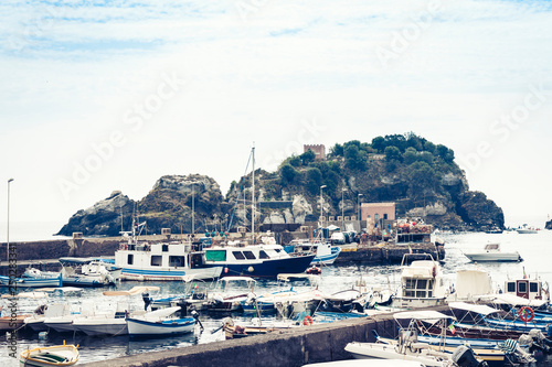 Acitrezza harbor with fisher boats next to Cyclops islands, Catania, Sicily © Inna