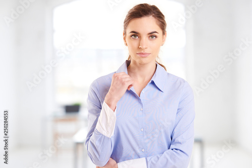 Young professional businesswoman portrait while standing in the office