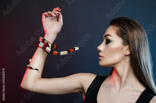 sensual woman and ring snake in studio