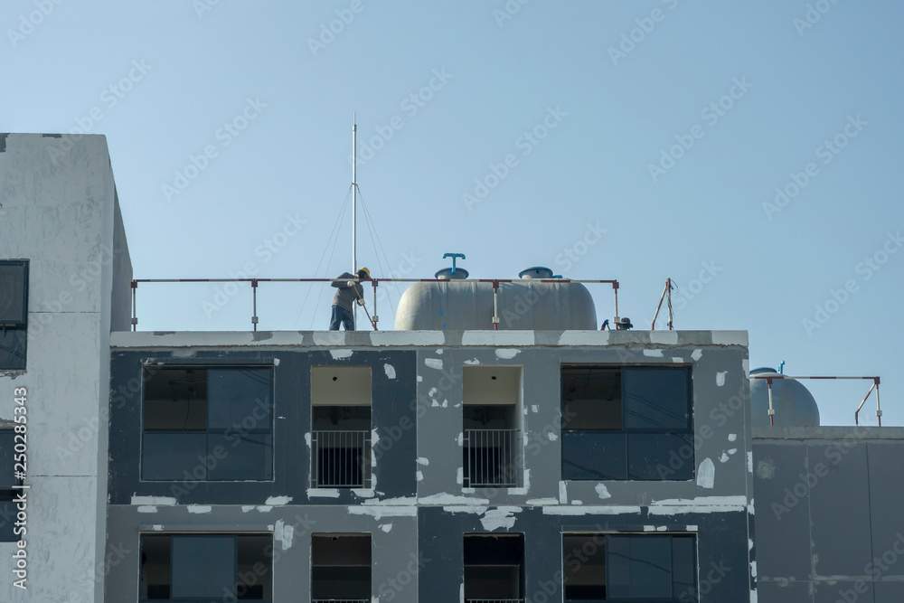 Building renovation and worker working on the building Building renovation and worker working on the building