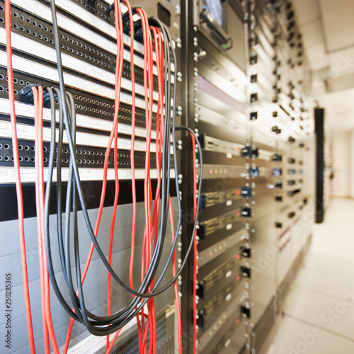Close up of computer servers and cords in server room