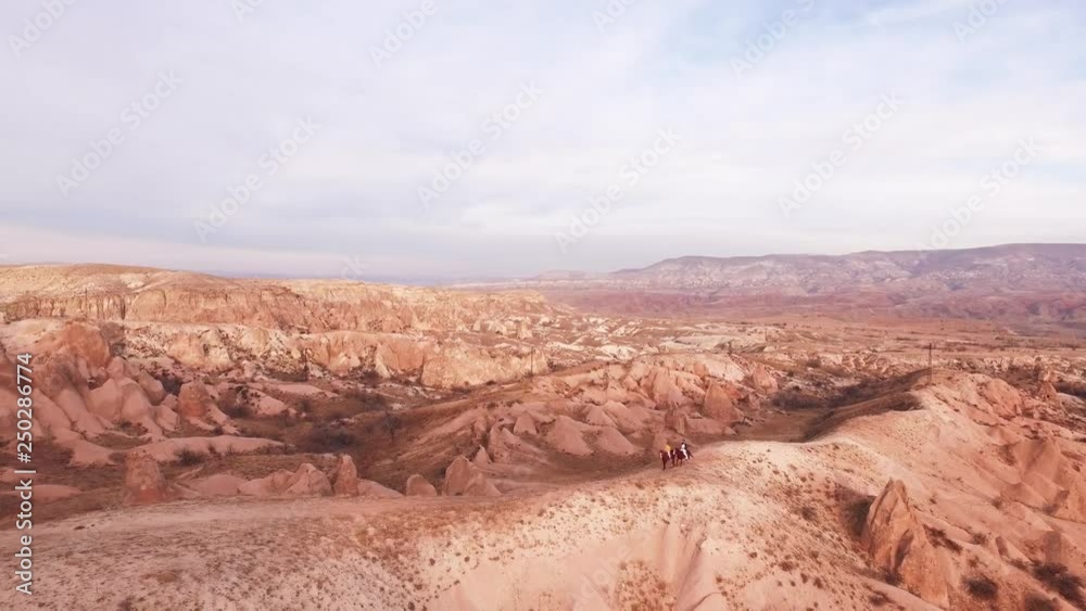 two people horse riding in Cappadocia, aerial view two people horse riding in Cappadocia, aerial view