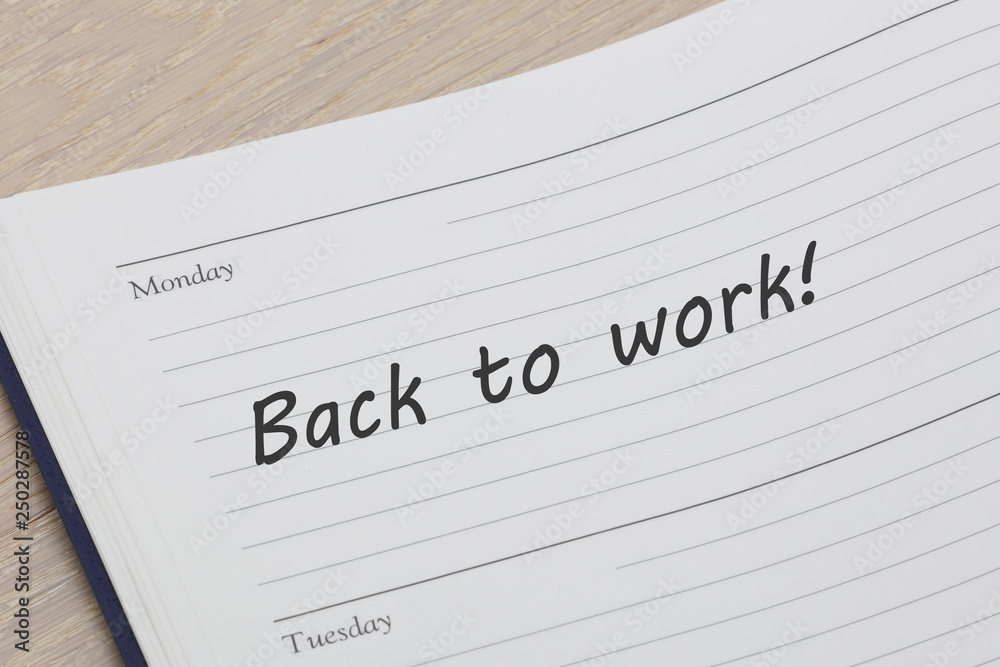 Back to work diary reminder open on desk Back to work diary reminder open on desk