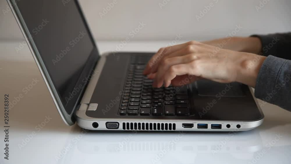 young woman hands typing on a laptop young woman hands typing on a laptop